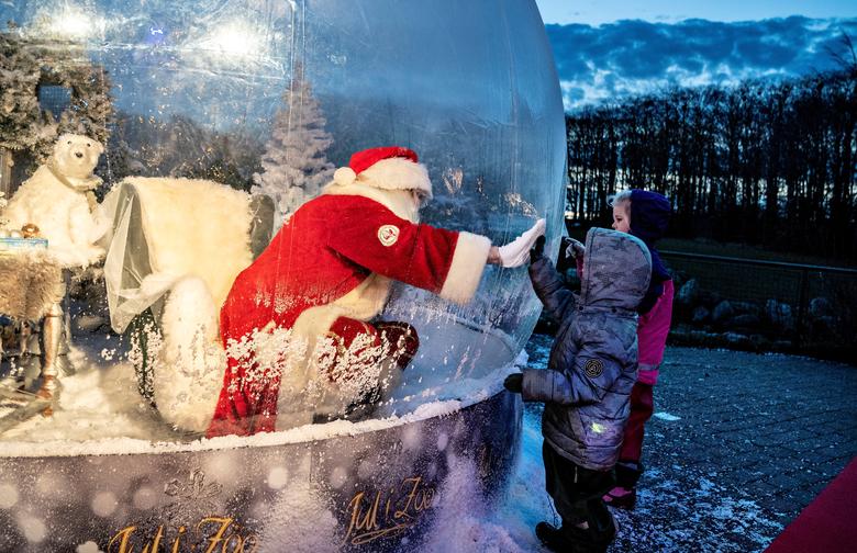 Дания. Санта Клаус в стеклянном шаре встречает детей во время пандемии коронавируса / ноябрь 2020 / Reuters